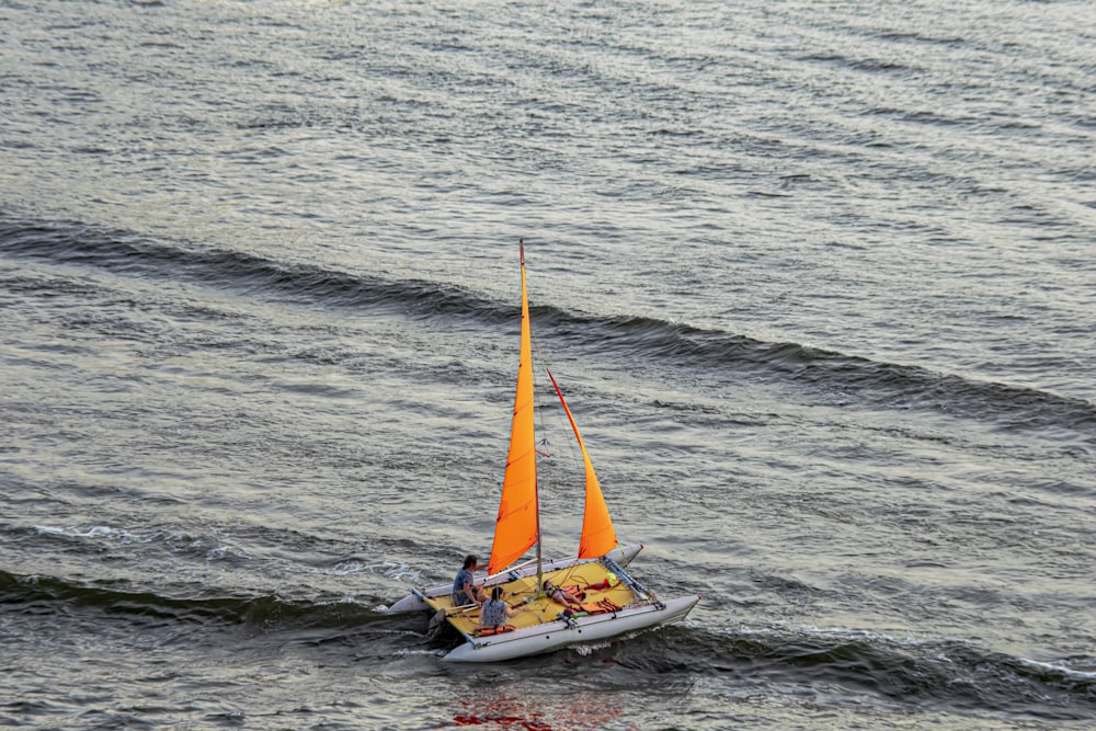 a boat with people on it sailing on the water