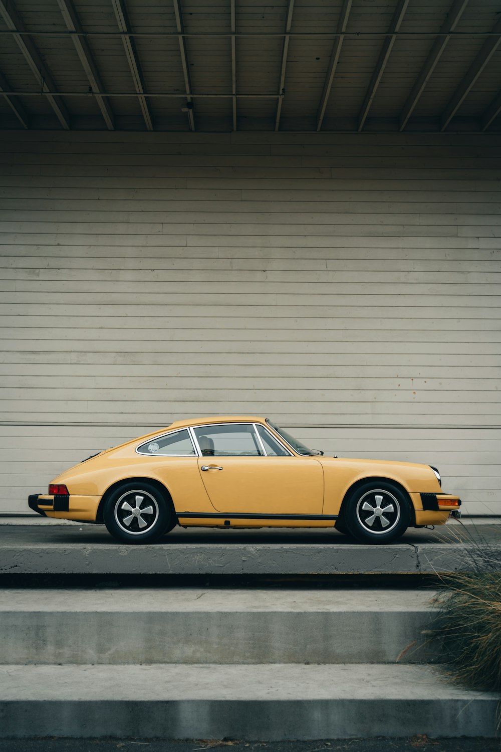 a yellow car parked in front of a building