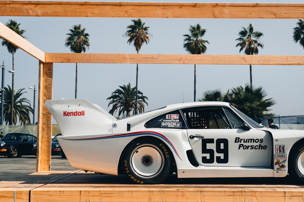 a race car parked in front of a sign