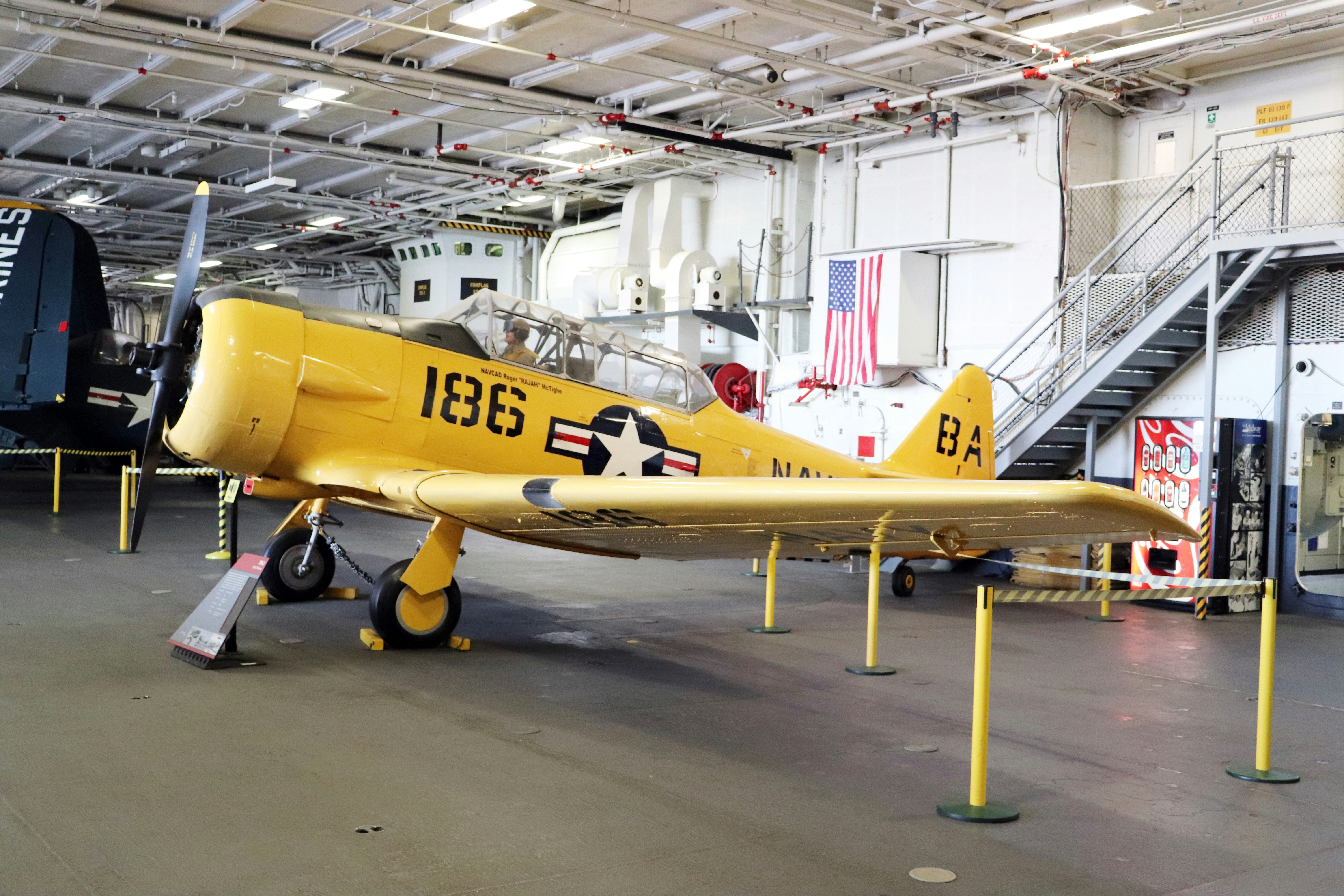 a yellow plane in a hangar