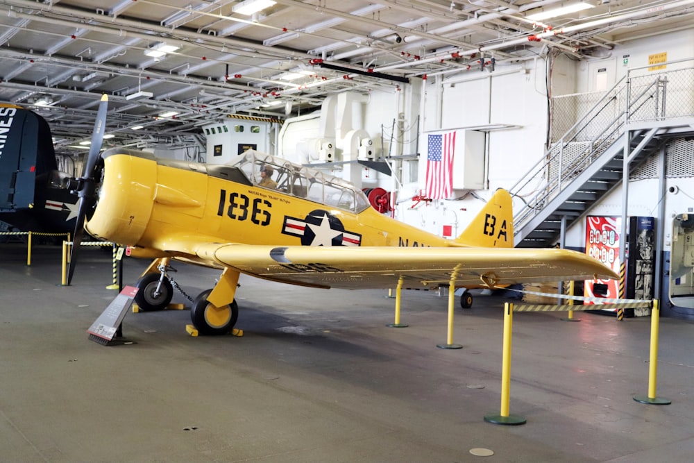 a yellow plane in a hangar