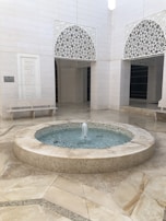 A peaceful mosque courtyard with intricate Islamic geometric patterns.