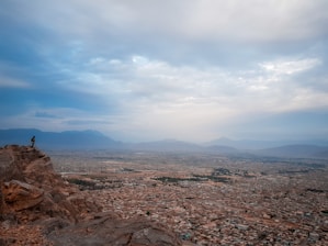a person standing on a rocky hill