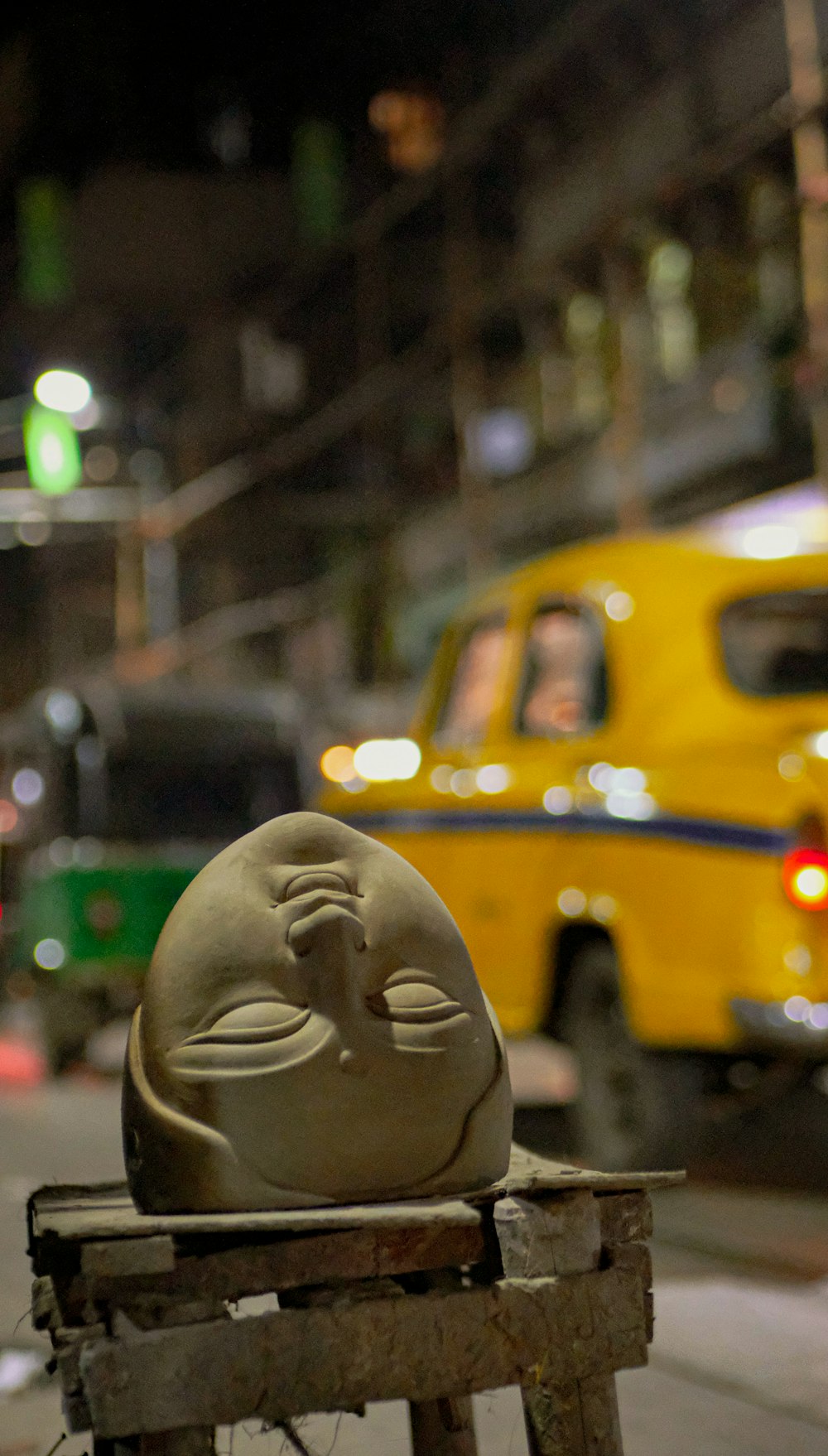 a yellow toy on a stack of bricks