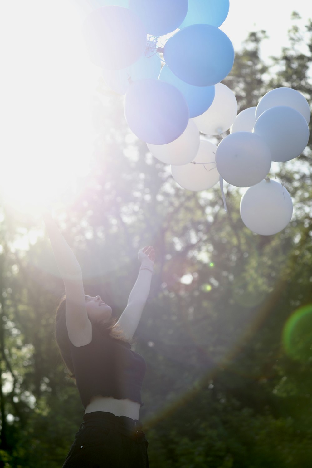 a person holding a bunch of balloons