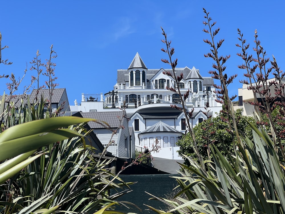 a white house with a pool in front of it