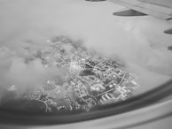 Nighttime cityscape with airplane flying overhead symbolizing international opportunities.