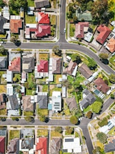 Aerial view of a modern residential neighborhood with houses and green spaces.