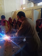 Happy small business owners from welding community celebrating success.