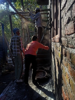 Team of plastering professionals in lime green and charcoal uniforms collaborating on site.