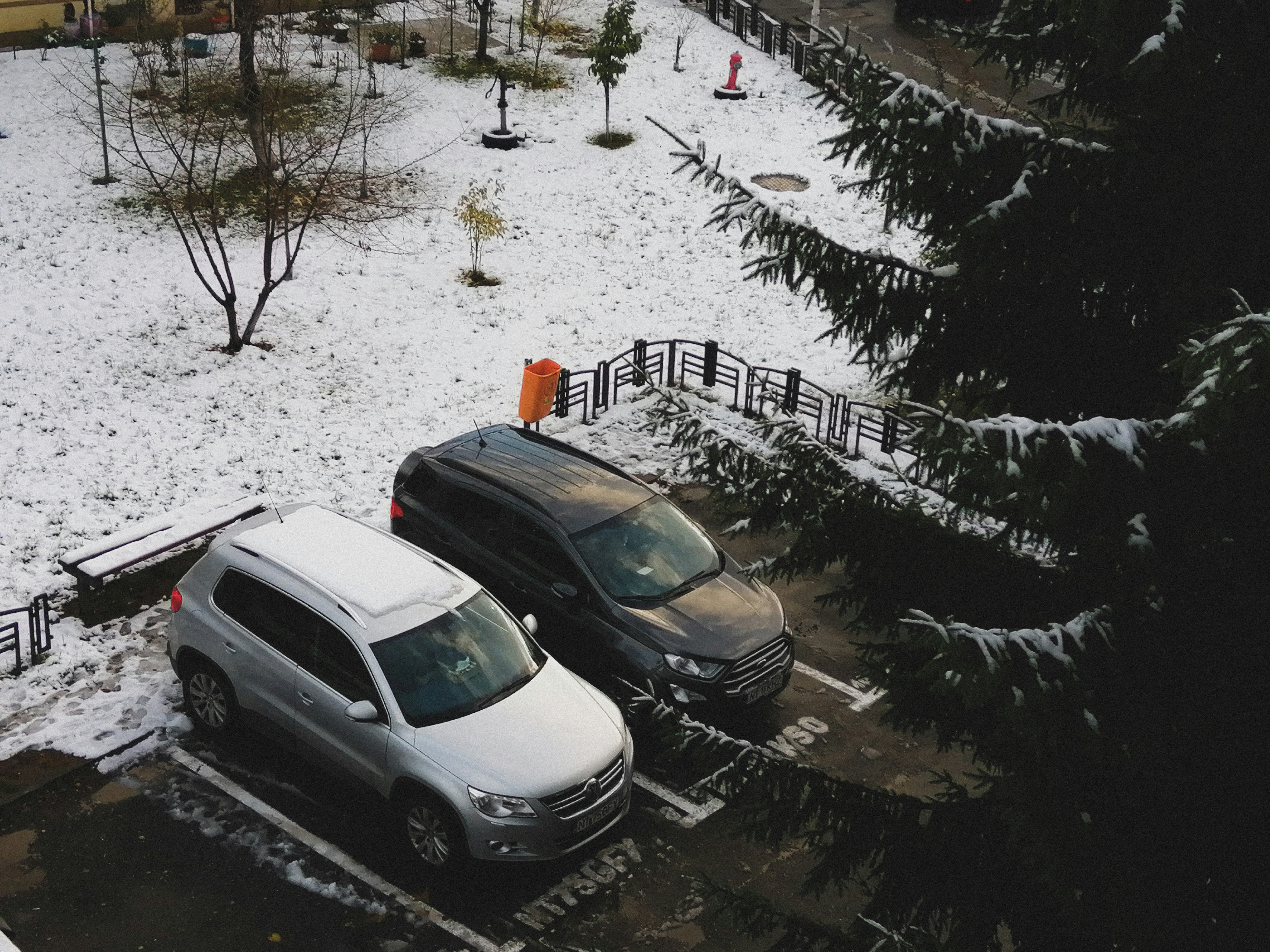 Electric car charging in winter snow, illustrating impact of cold on battery cooling and range