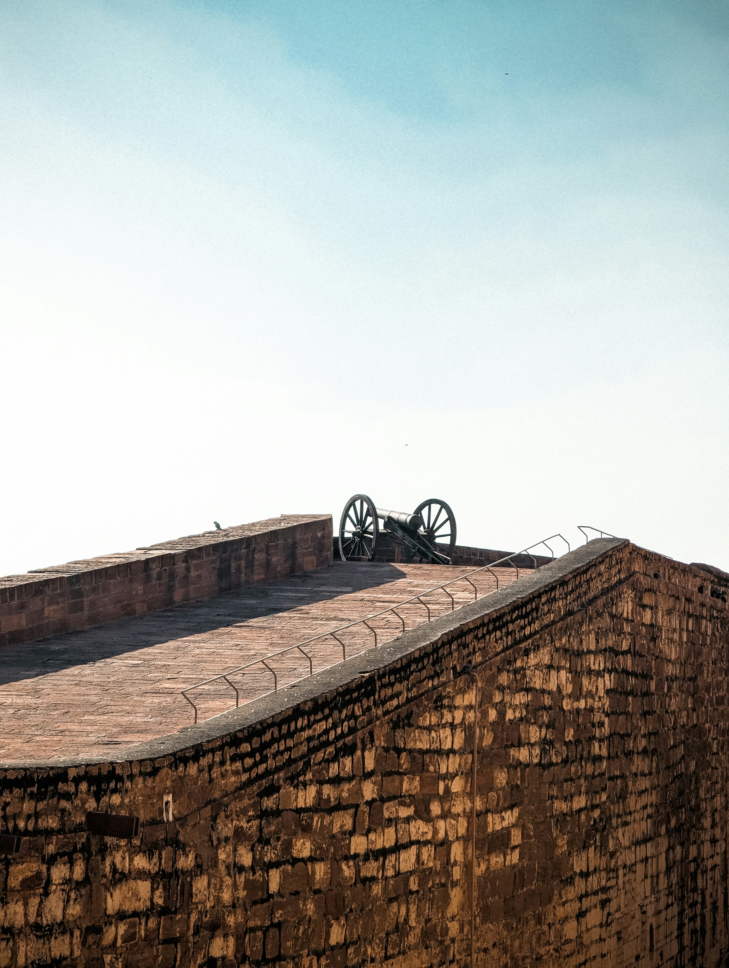 a brick building with a bike on top