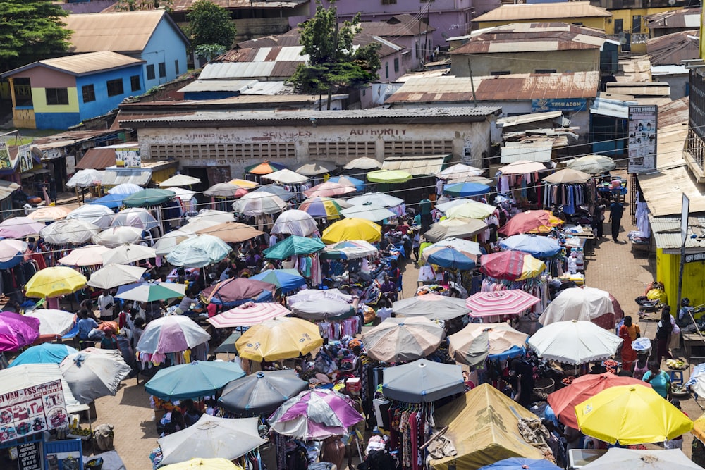 a large crowd of people are holding umbrellas