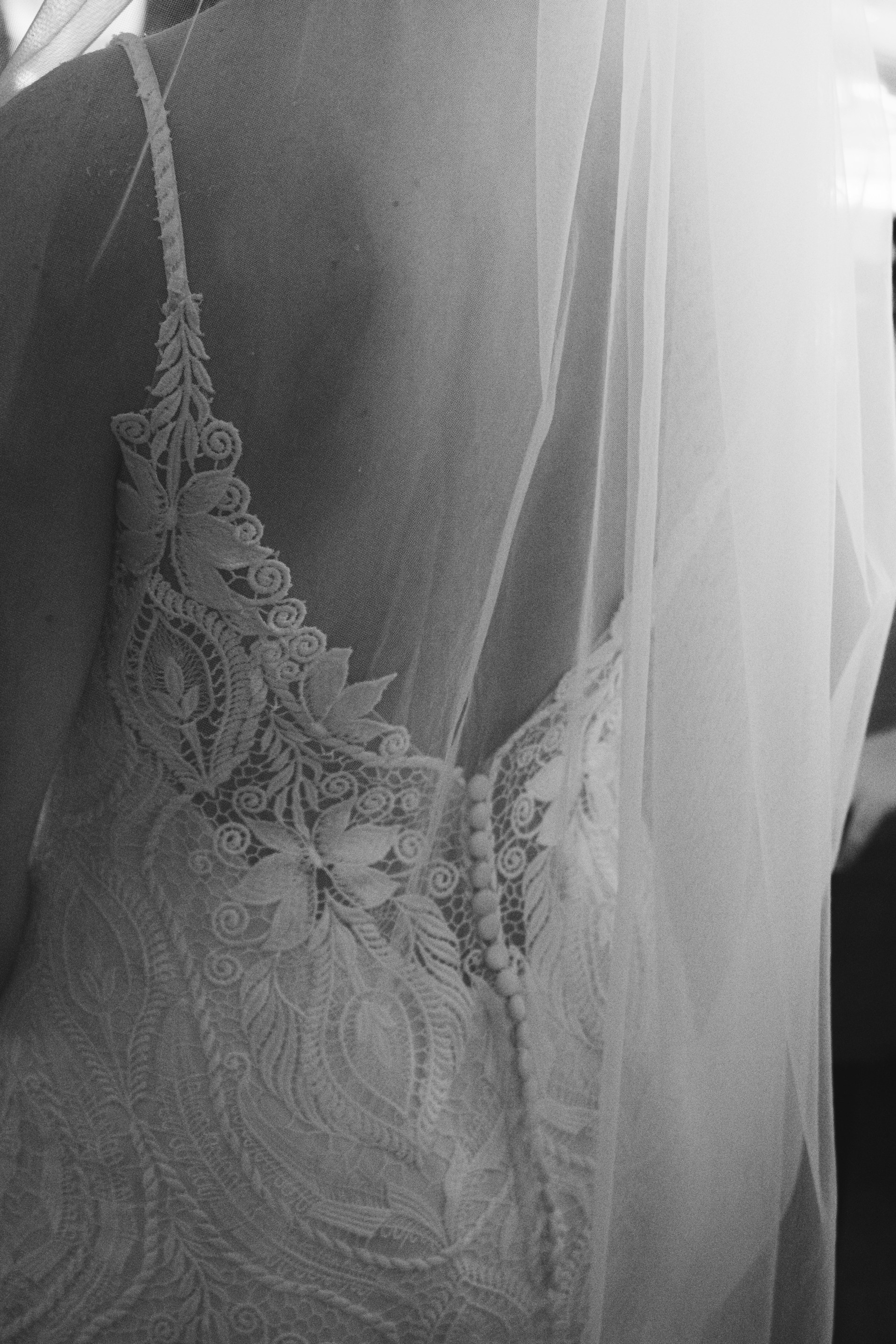 Close-up of the bride's dress, featuring a delicate white gown with a luxurious fur cape, capturing the romantic essence of a winter wedding.