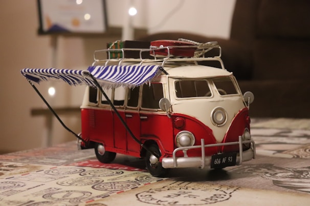 3D printed custom parts neatly arranged next to a Pilote camper van model.