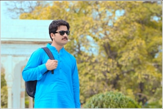 An ambitious Indian student with a backpack and laptop standing confidently, with global university landmarks faintly visible behind.