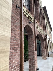 A cozy Armenian guesthouse with traditional stone architecture and flower-filled windows.