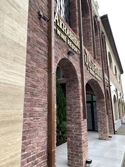 A cozy Armenian guesthouse with traditional stone architecture and flower-filled windows.