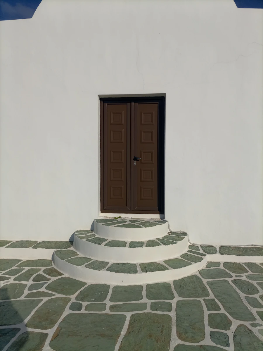 A blue door on a whitewashed wall