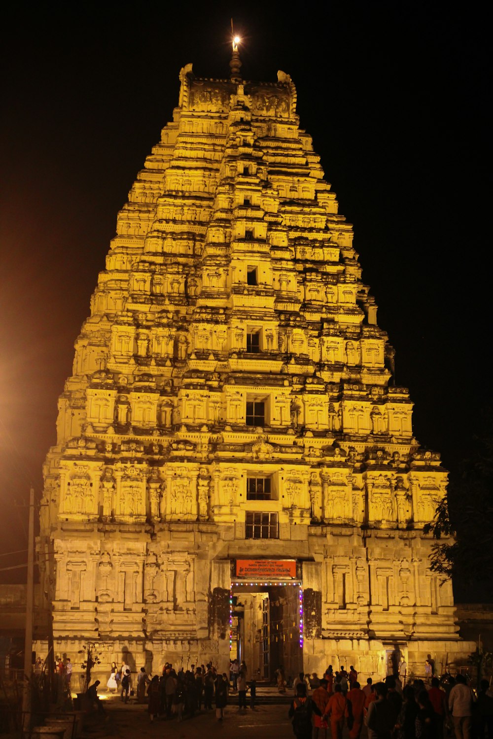 a large stone building with people standing in front of it