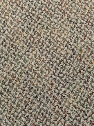Close-up of a carpet with stains being treated.
