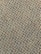A close-up view of a textured carpet with a speckled pattern. The surface consists of tightly woven loops in various colors, predominantly gray, with interspersed specks of red, orange, yellow, and green.