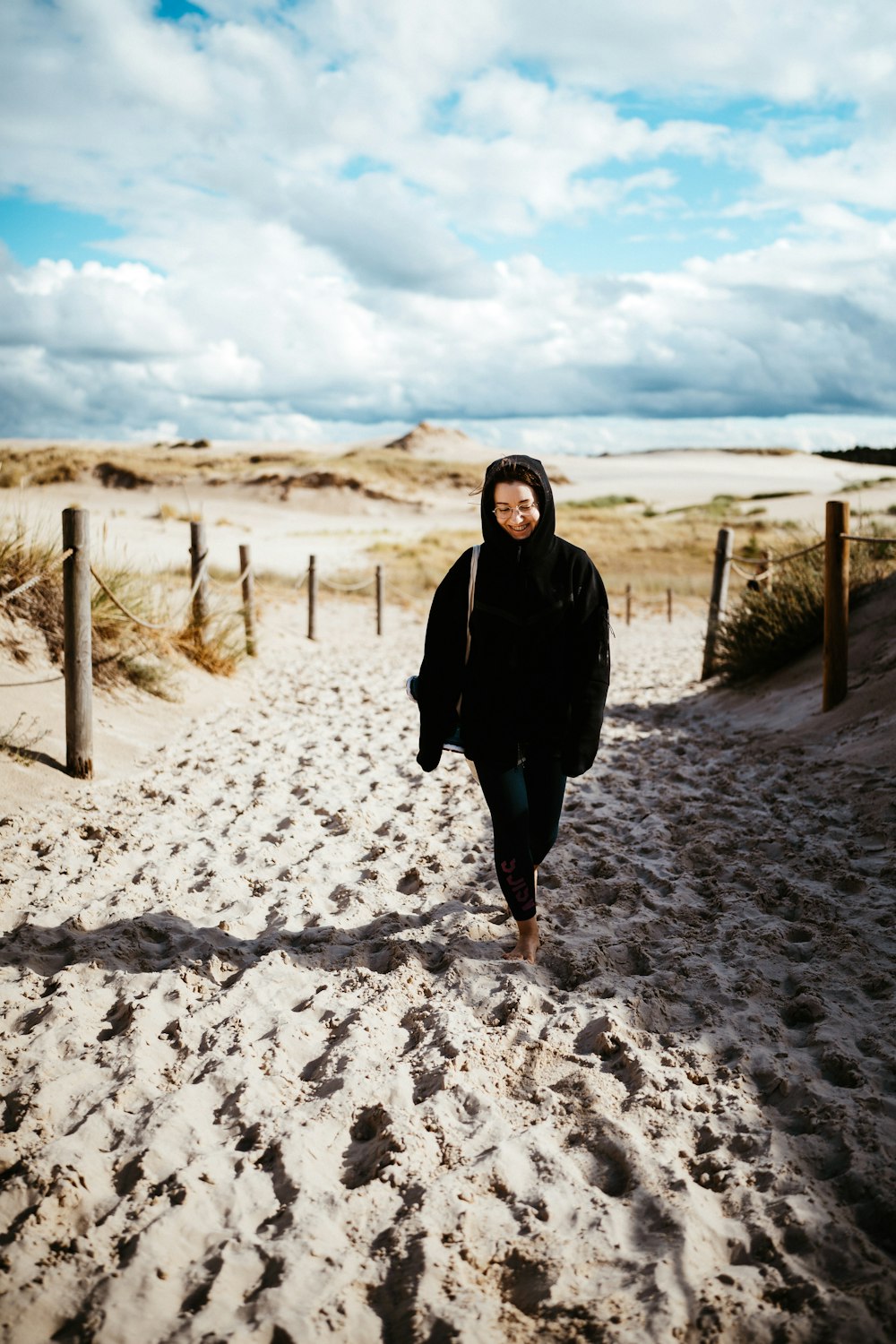 a man walking on a sandy beach