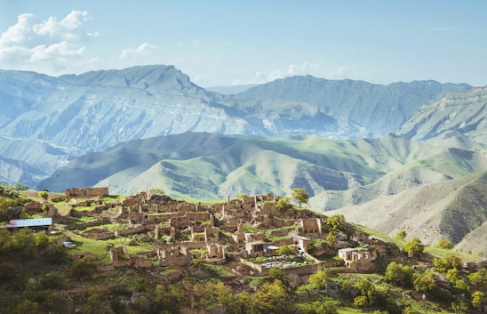 a small village in front of a mountain range