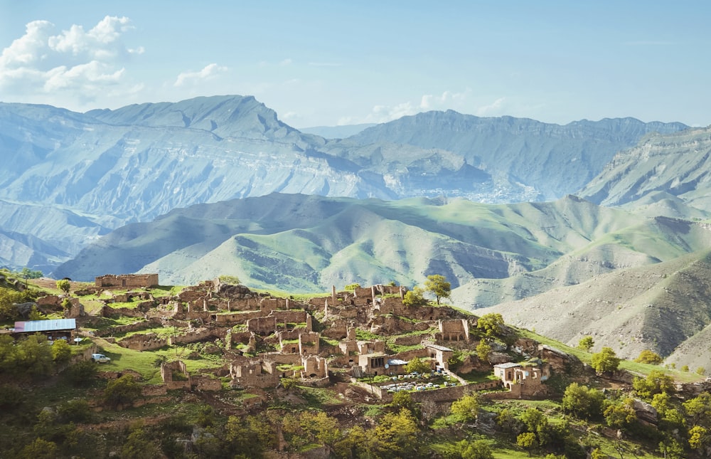 a small village in front of a mountain range