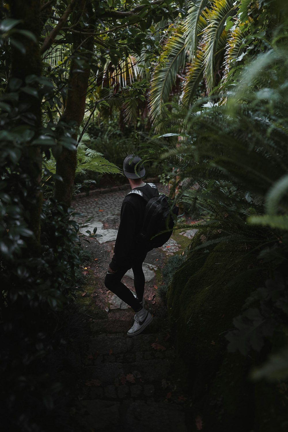 a man walking on a path in the woods