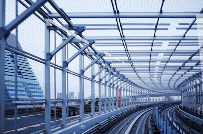 a train station with a large glass ceiling