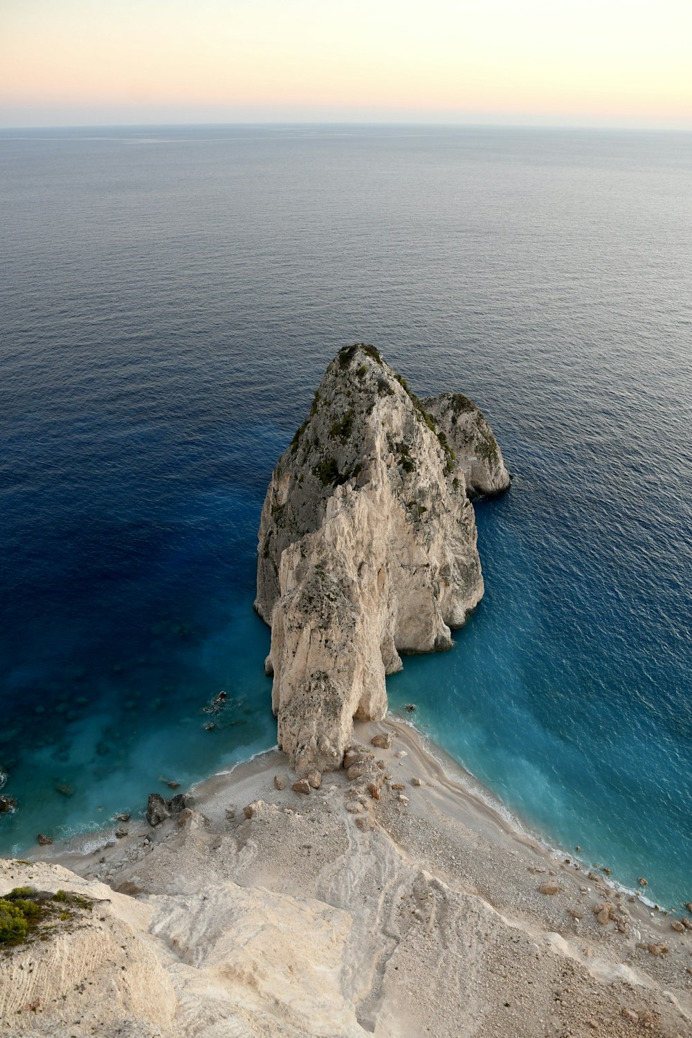 a large rock in the middle of a body of water