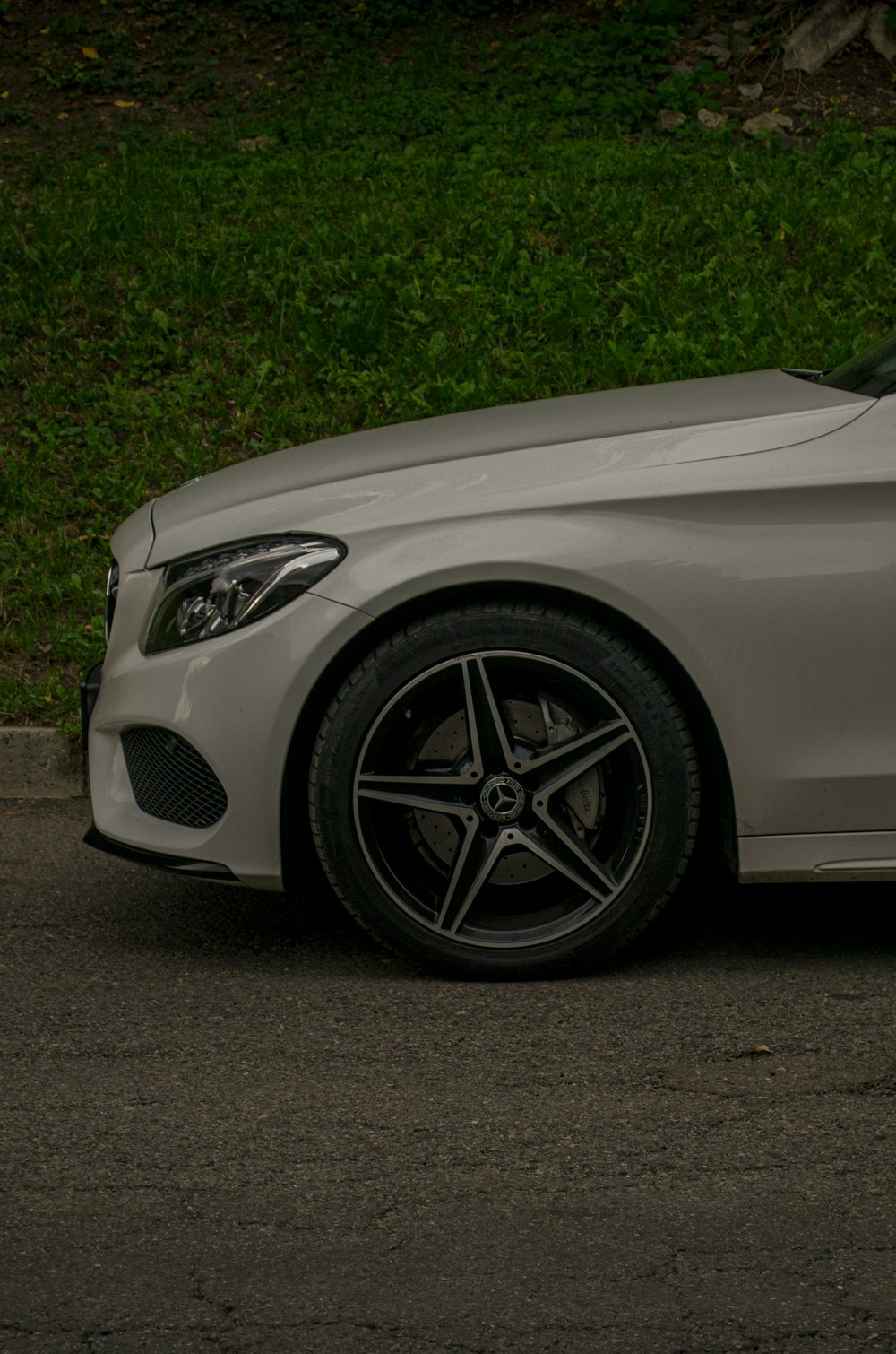 a silver car parked on the side of a road