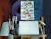 An artistic workspace featuring a wooden easel with a paper displaying sketches of lips, surrounded by various brushes and art tools. The walls have graffiti and abstract designs, adding an urban and creative atmosphere.
