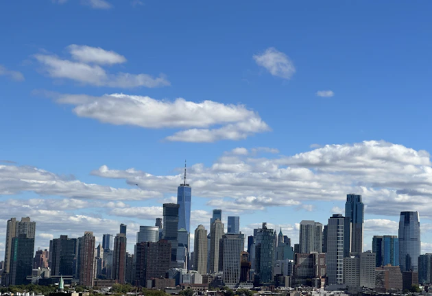 A sparkling clean office window reflecting the city skyline on a sunny day.