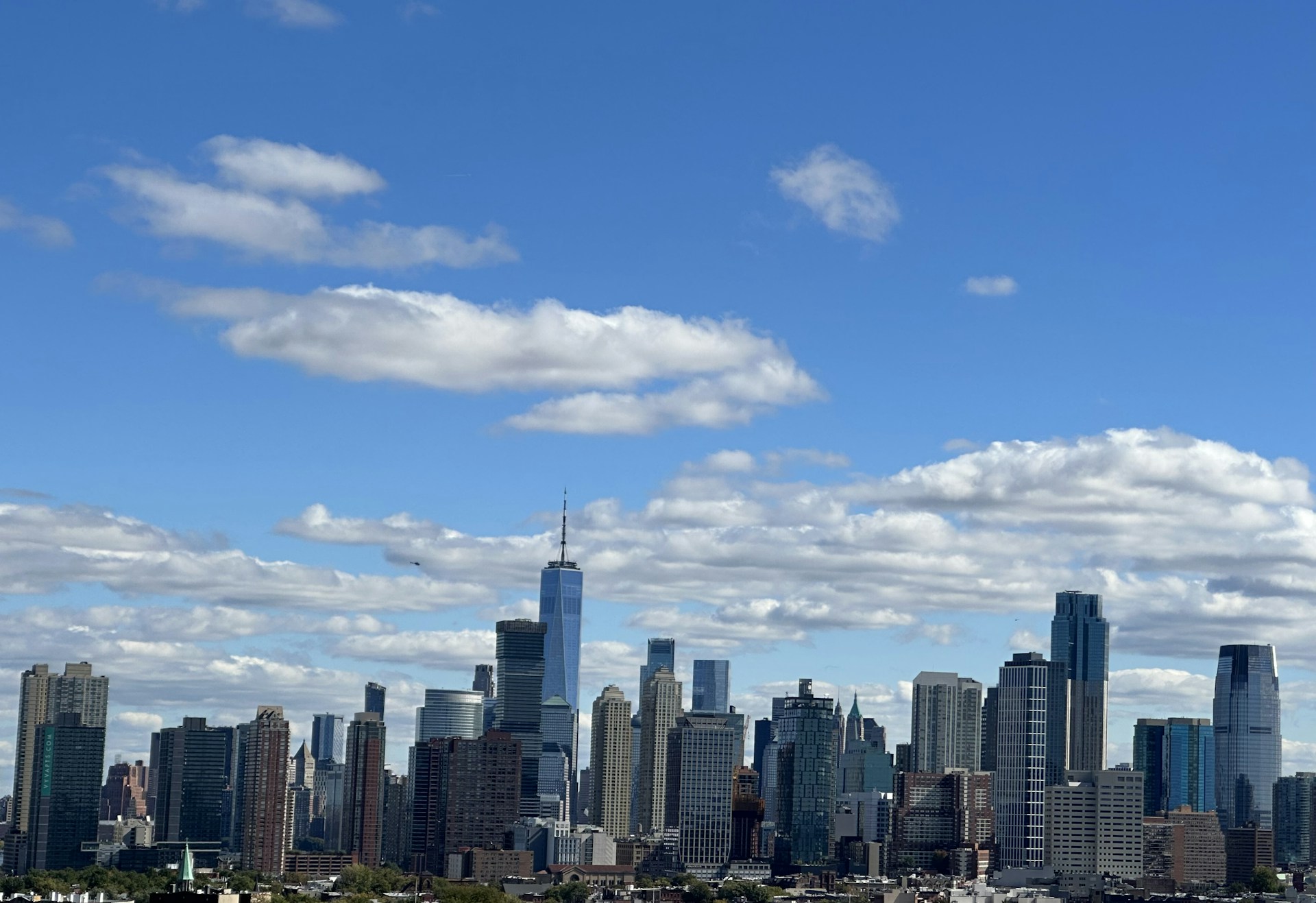 woman wearing yellow long-sleeved dress under white clouds and blue sky during daytime