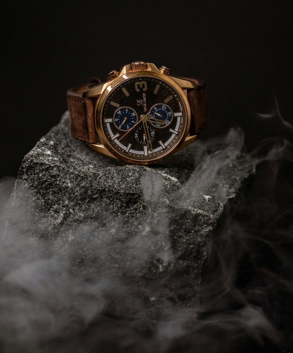 a watch on a rock