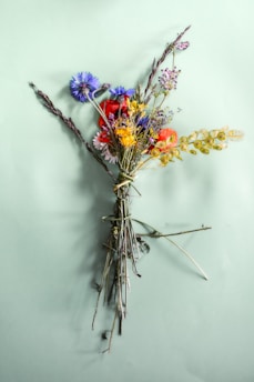 A vibrant custom-painted bouquet of wildflowers in soft pastels on canvas.