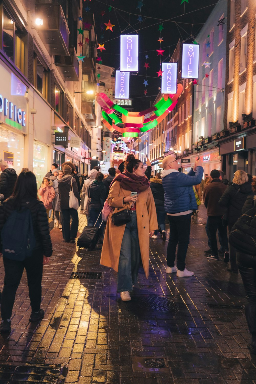 a crowd of people walking through a city