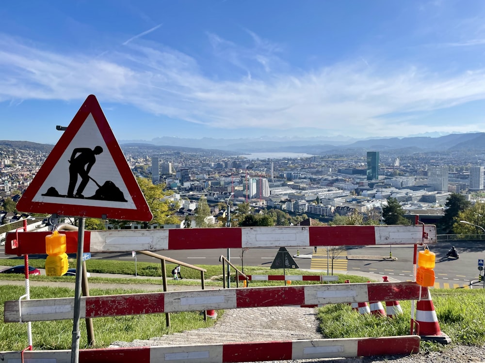 a road sign with a city in the background