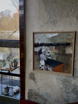 A framed abstract painting by Joe Malkovich hanging on a gallery wall.