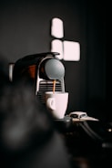 A sleek automated beverage service robot preparing drinks.