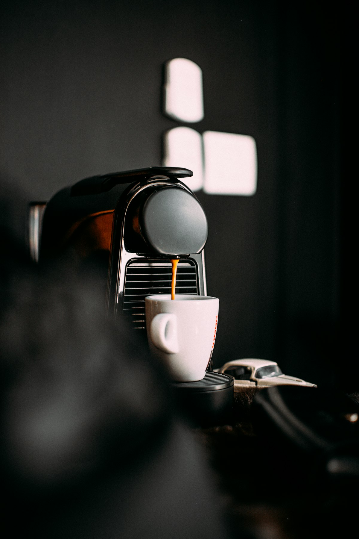 Nespresso coffee machine brewing espresso into a cup — capsule machines are the fastest-growing segment in China's home coffee market
