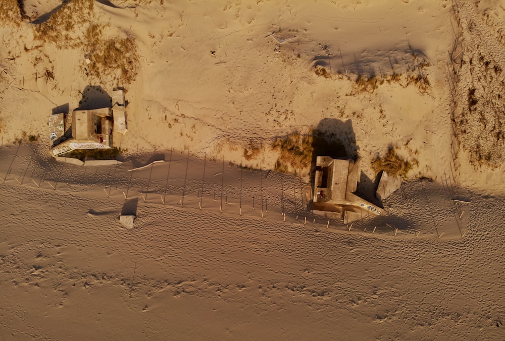 a stone building with a fence and a dirt road