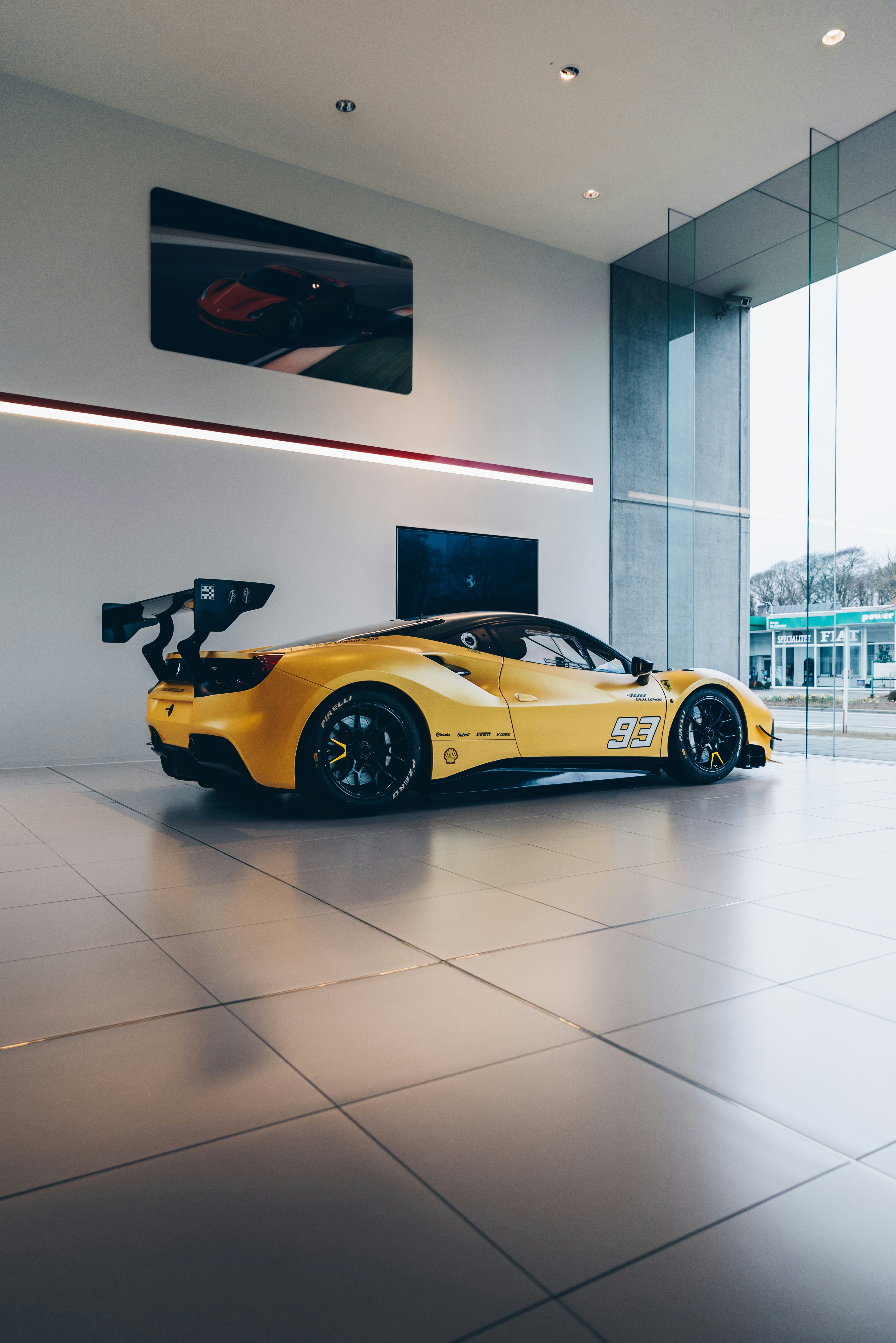 A yellow sports car in a showroom photo Free Car Image on Unsplash