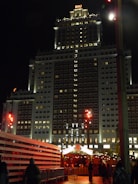 Night view of Riu Palace Vallarta illuminated with warm lights.