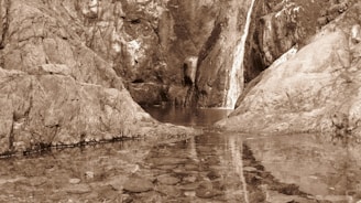 a waterfall over a body of water