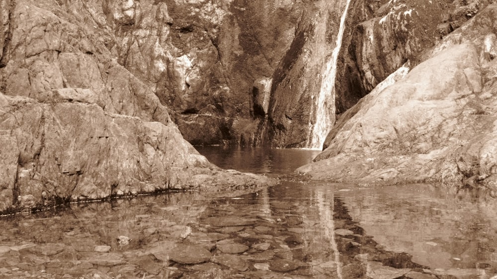 a waterfall over a body of water