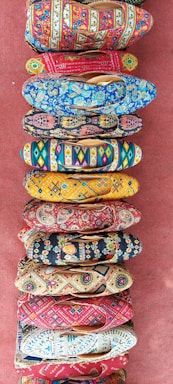 A collection of colorful handmade shoes for women arranged aesthetically.