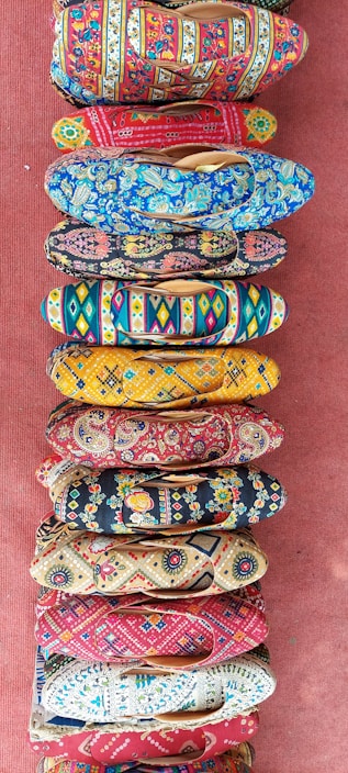 A collection of colorful handmade shoes for women arranged aesthetically.